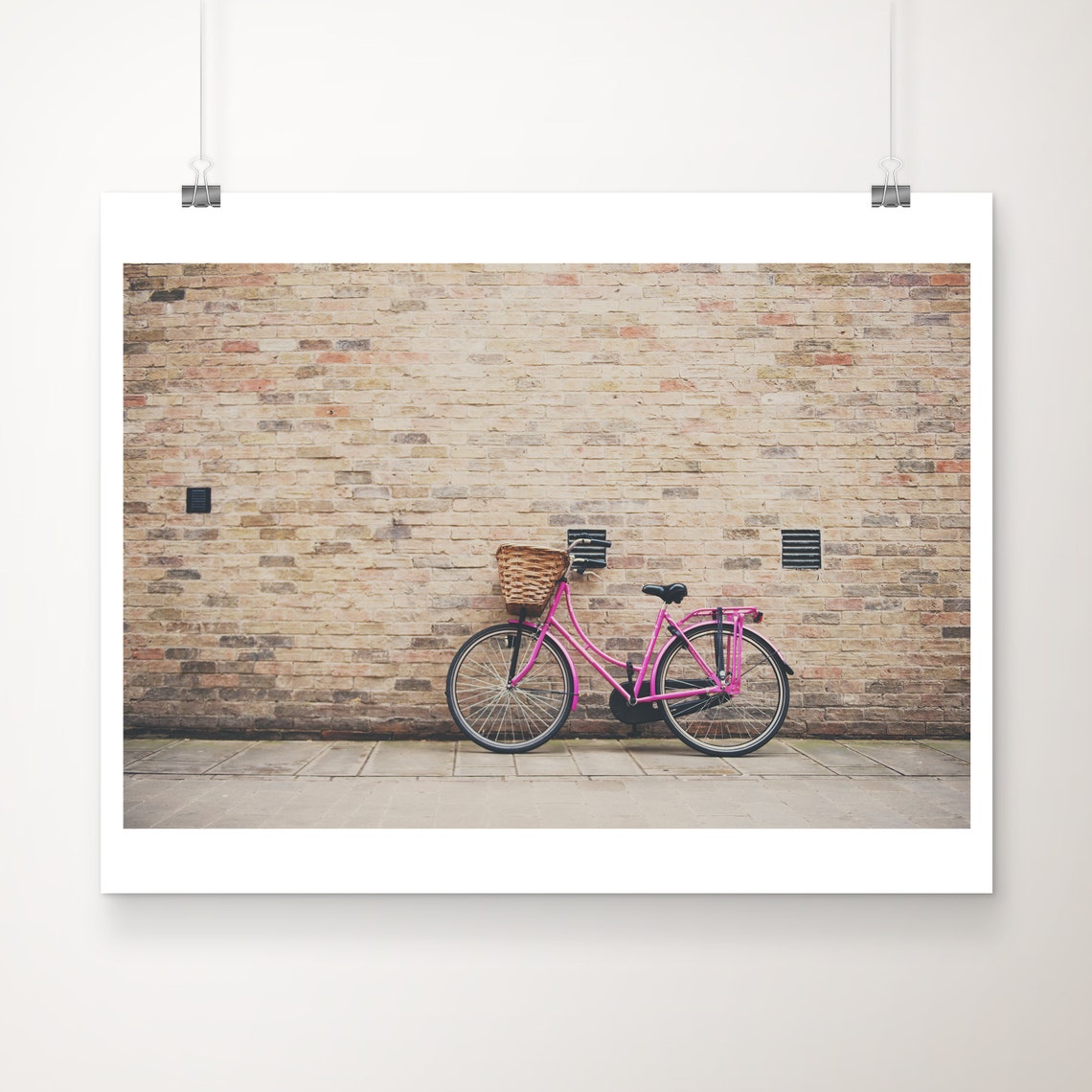 Pink Bicycle With Wicker Basket Against Old Brick Wall Travel Poster