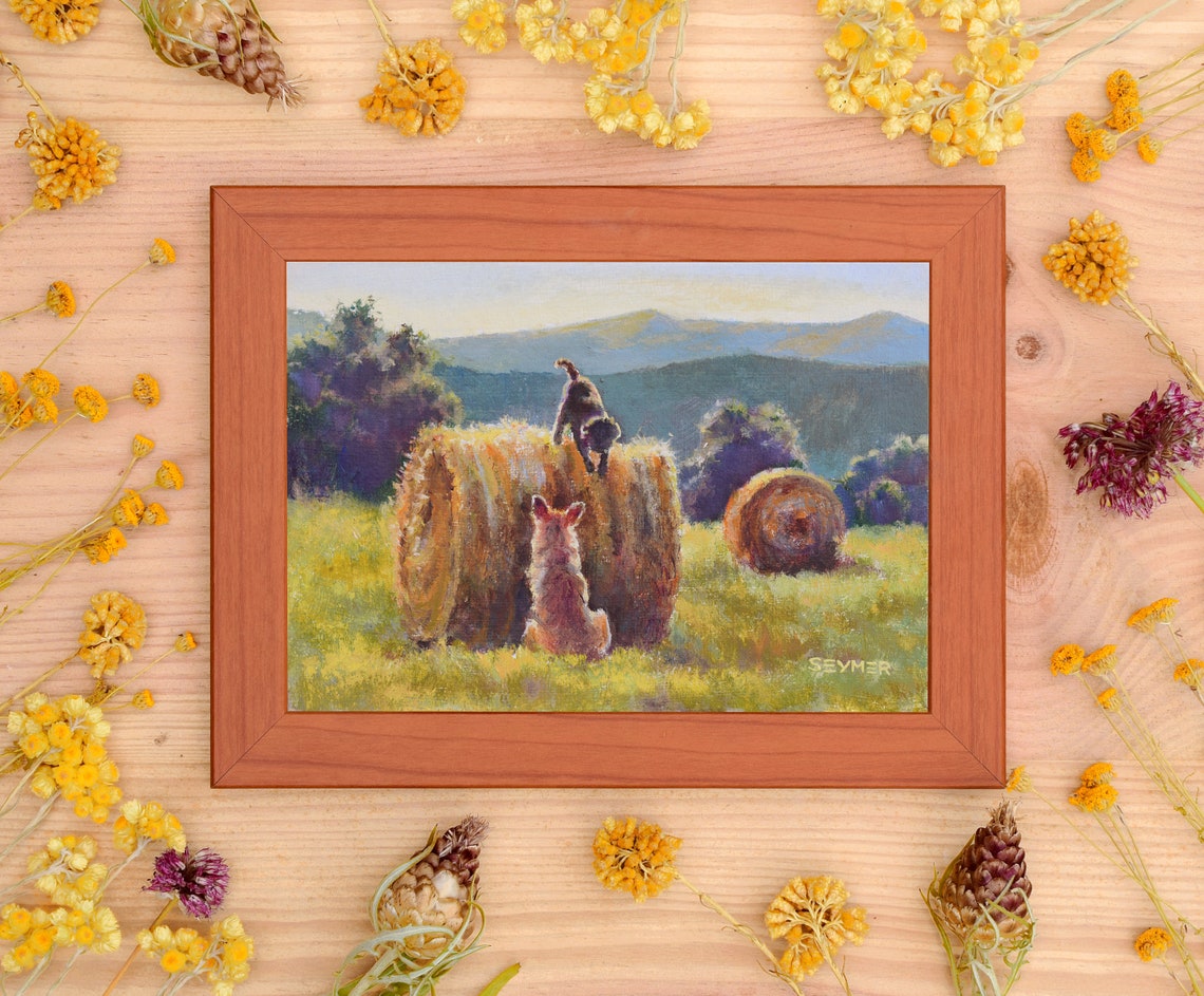 Two Playful Dogs Climbing on Hay Bales at Golden Hour Poster - Image 2