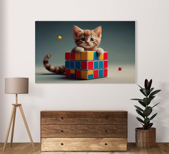 Cute Orange Kitten Hugging a Giant Colorful Rubik Cube Playfully Poster