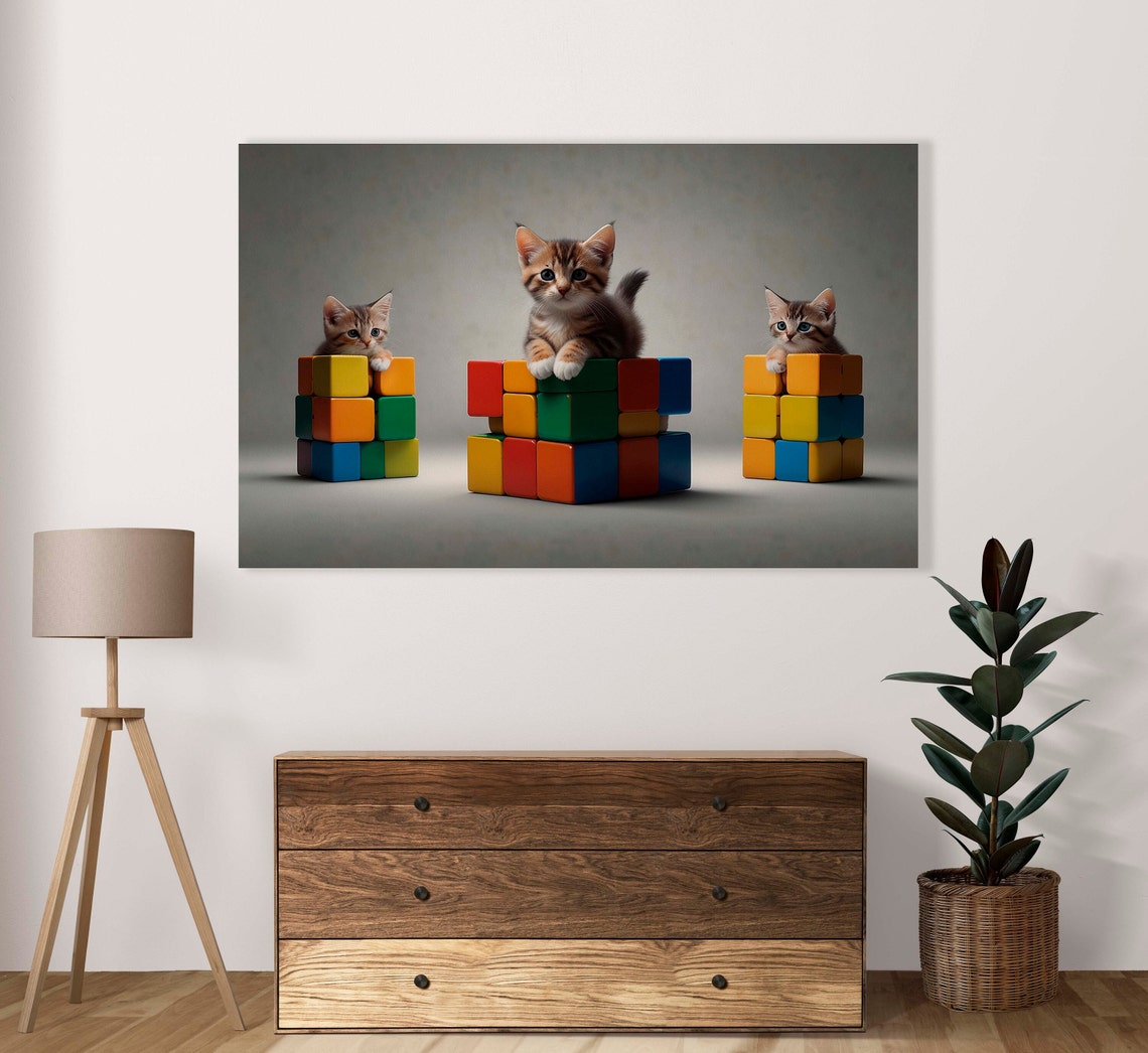 Three Adorable Tabby Kittens Draped Over Rubiks Cube Stacks Poster